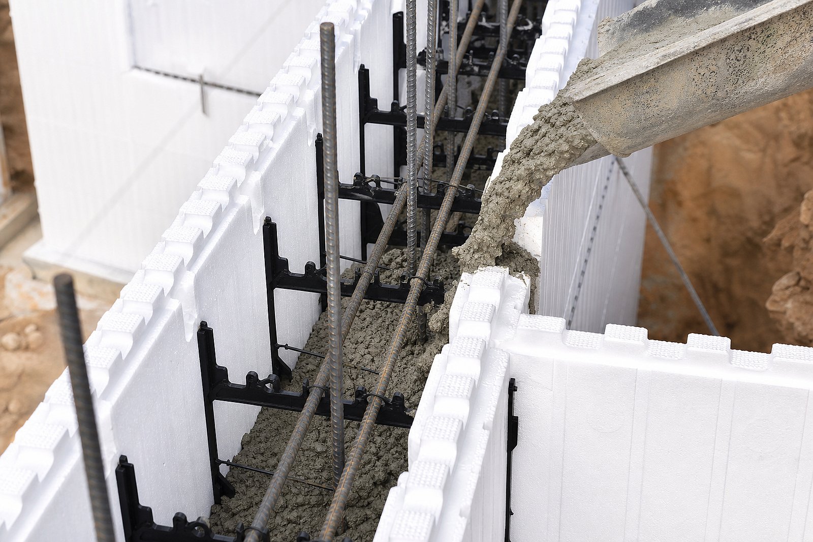 ICF insulated concrete form wall assembly being constructed with foam blocks and steel reinforcement at residential job site